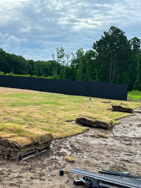 Black aluminum perimeter fence across property